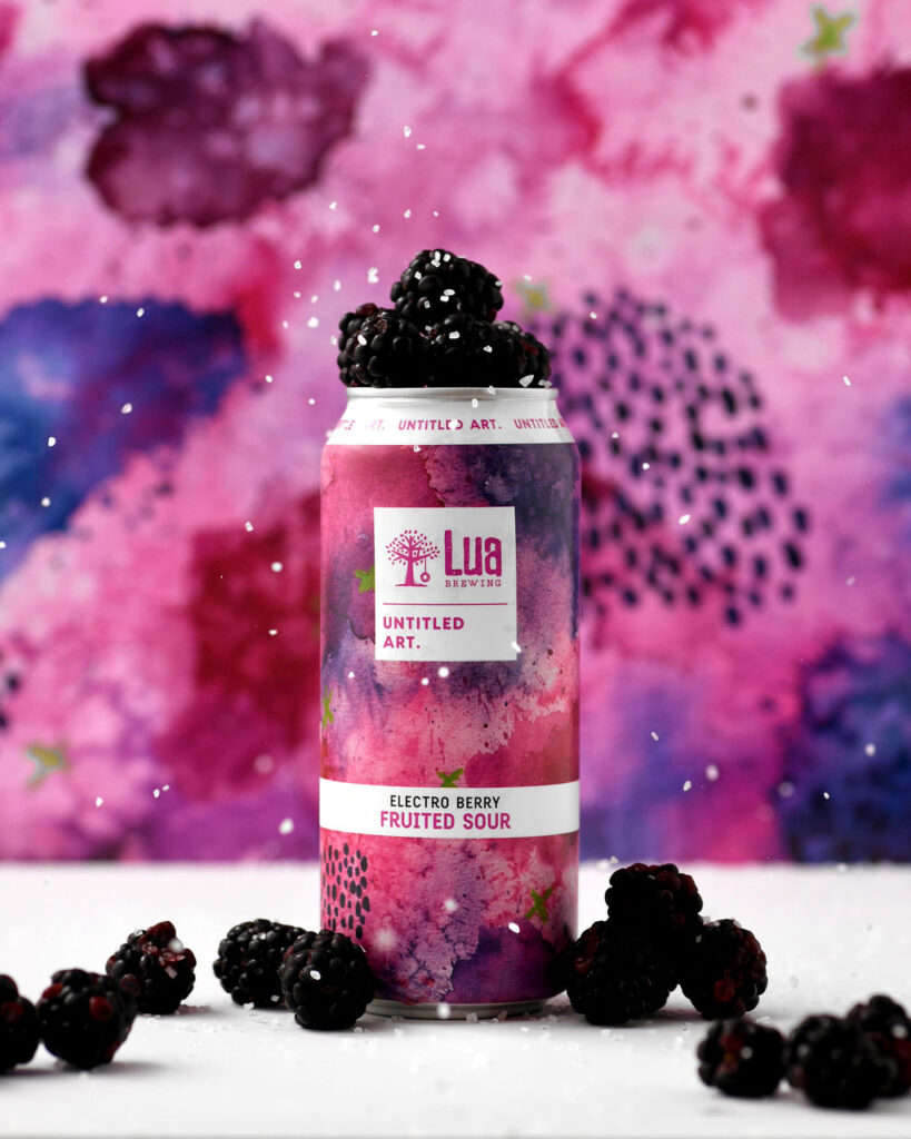 A can of blackberry beer on a colorful background.